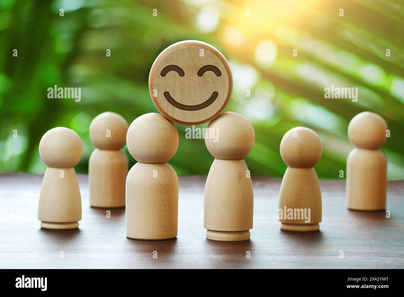 Wooden doll and smiley face emoticon ball kay. Concept for assessment. Service ratings, feedback, satisfaction and mental health concepts Stock Photo