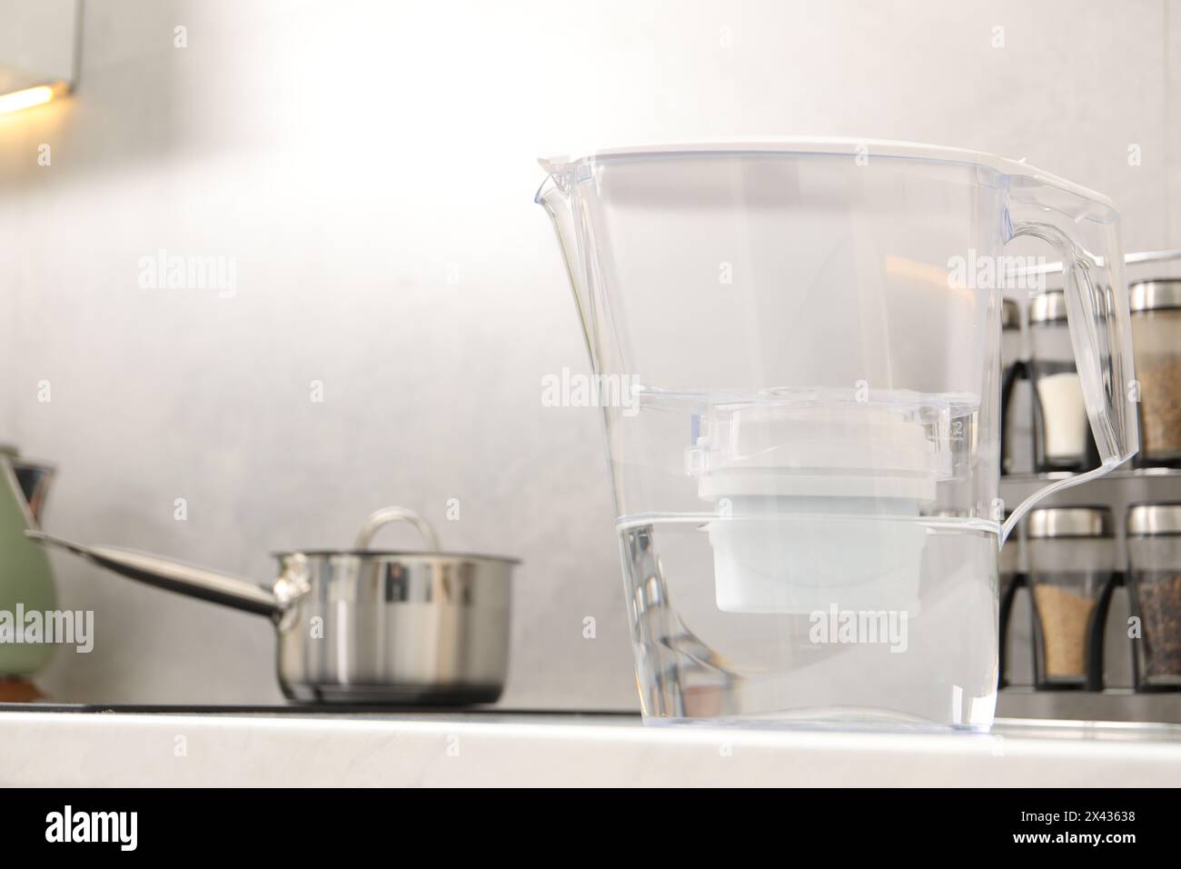 Water filter jug on countertop in kitchen Stock Photo
