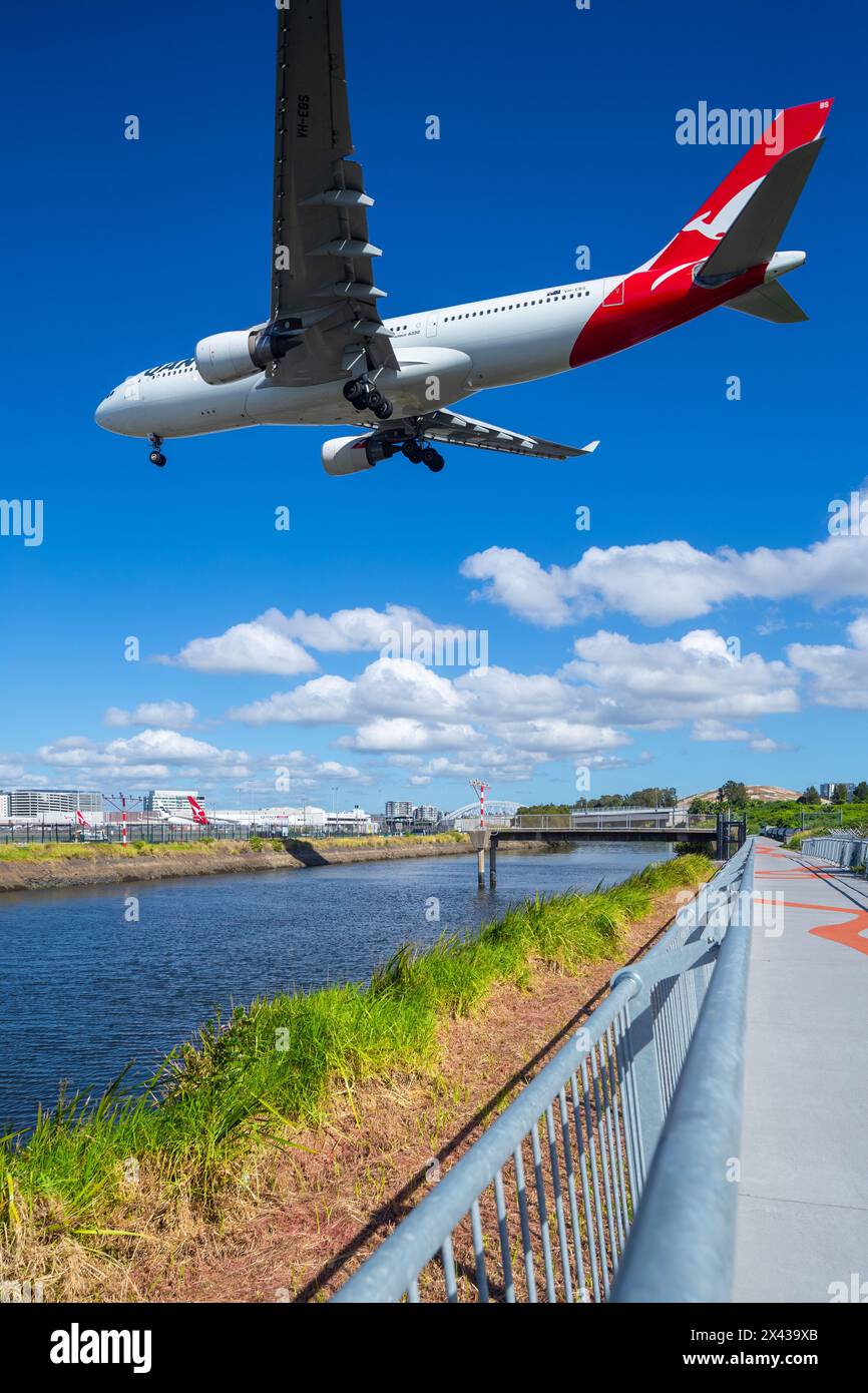 Aircraft above Alexandra Canal at Sydney Airport in Sydney, Australia. The canal is a tributary of the Cooks River which leads inland from Botany Bay. Stock Photo