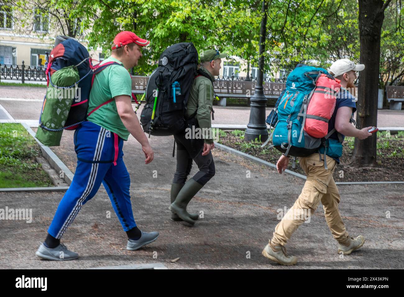 Young people go hiking with backpacks and tents along Tsvetnoy Boulevard in the center of Moscow, Russia Stock Photo