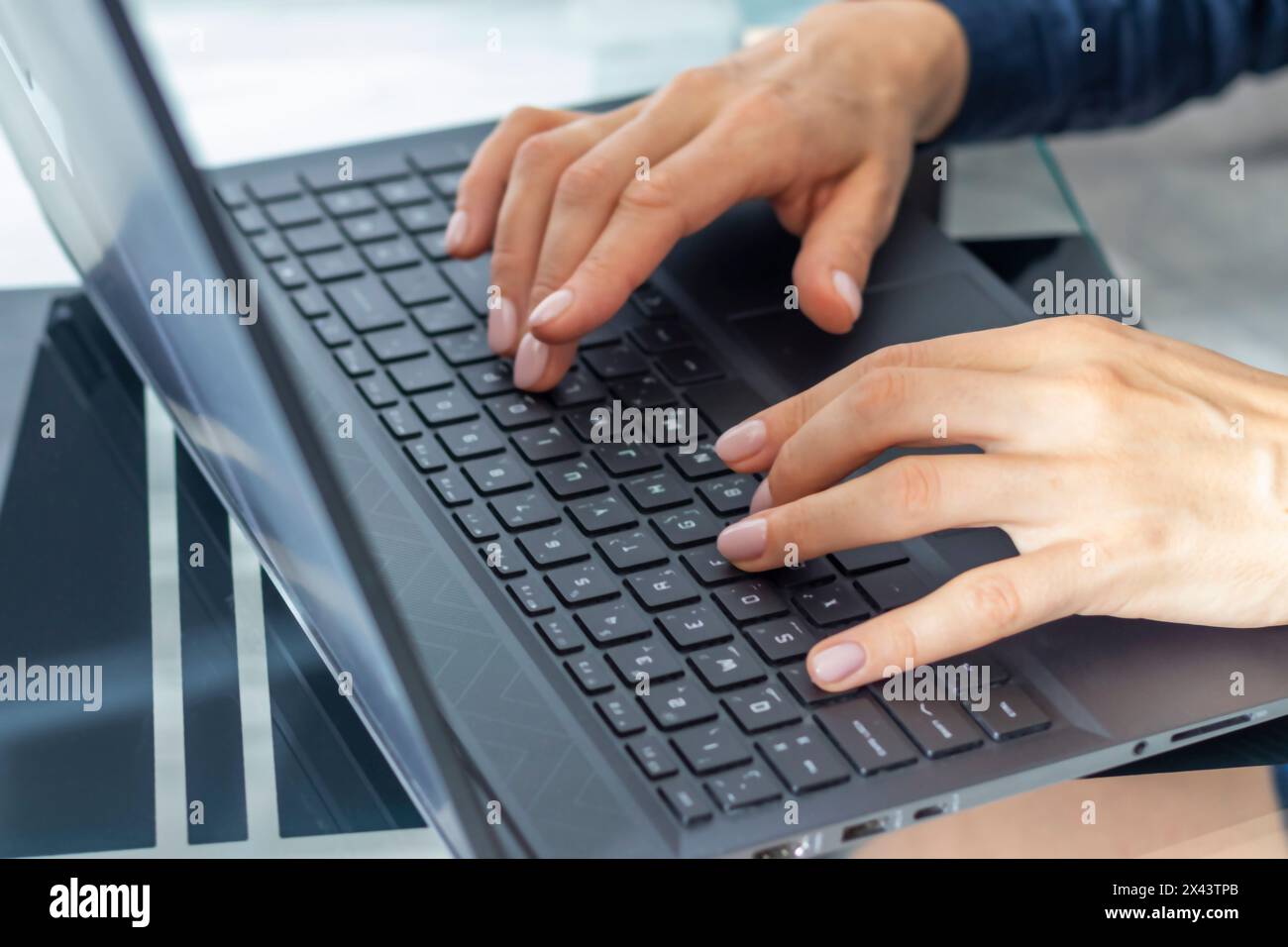 Close up shot of the woman with beautiful hands in the business attire, working on the laptop in the office Stock Photo