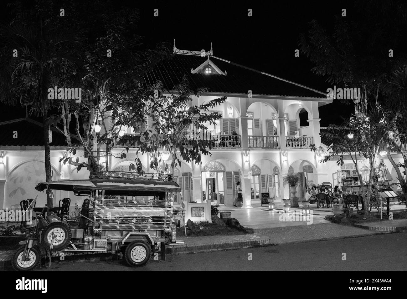 Nighttime street life with French colonial buildings in the historic old town of Luang Prabang, Laos Asia Stock Photo