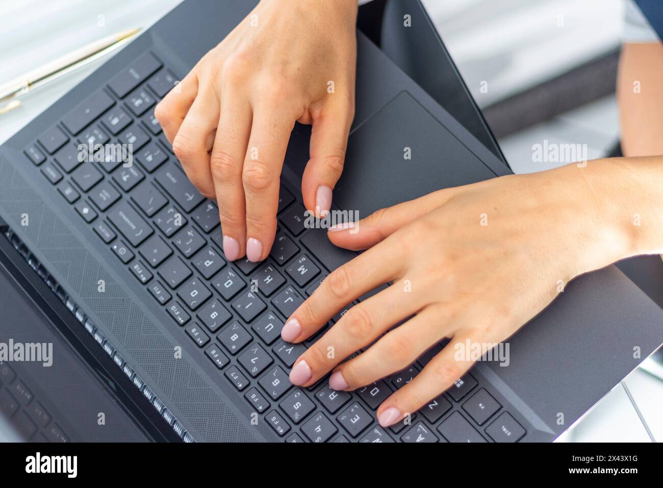 Close up shot of the woman with beautiful hands in the business attire, working on the laptop in the office Stock Photo