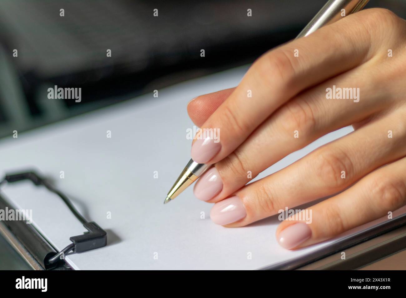Close up shot of the woman with beautiful hands in the business attire, working in the office, making notes Stock Photo
