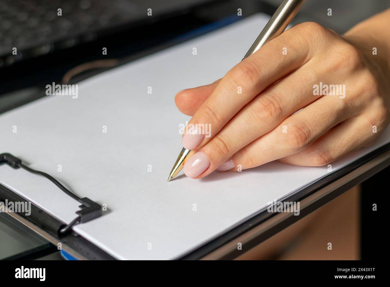 Close up shot of the woman with beautiful hands in the business attire, working in the office, making notes Stock Photo