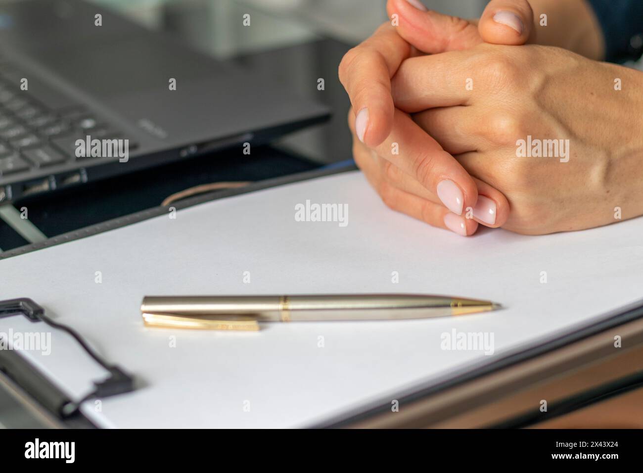 Close up shot of the woman with beautiful hands sitting in the meeting room during business meeting Stock Photo