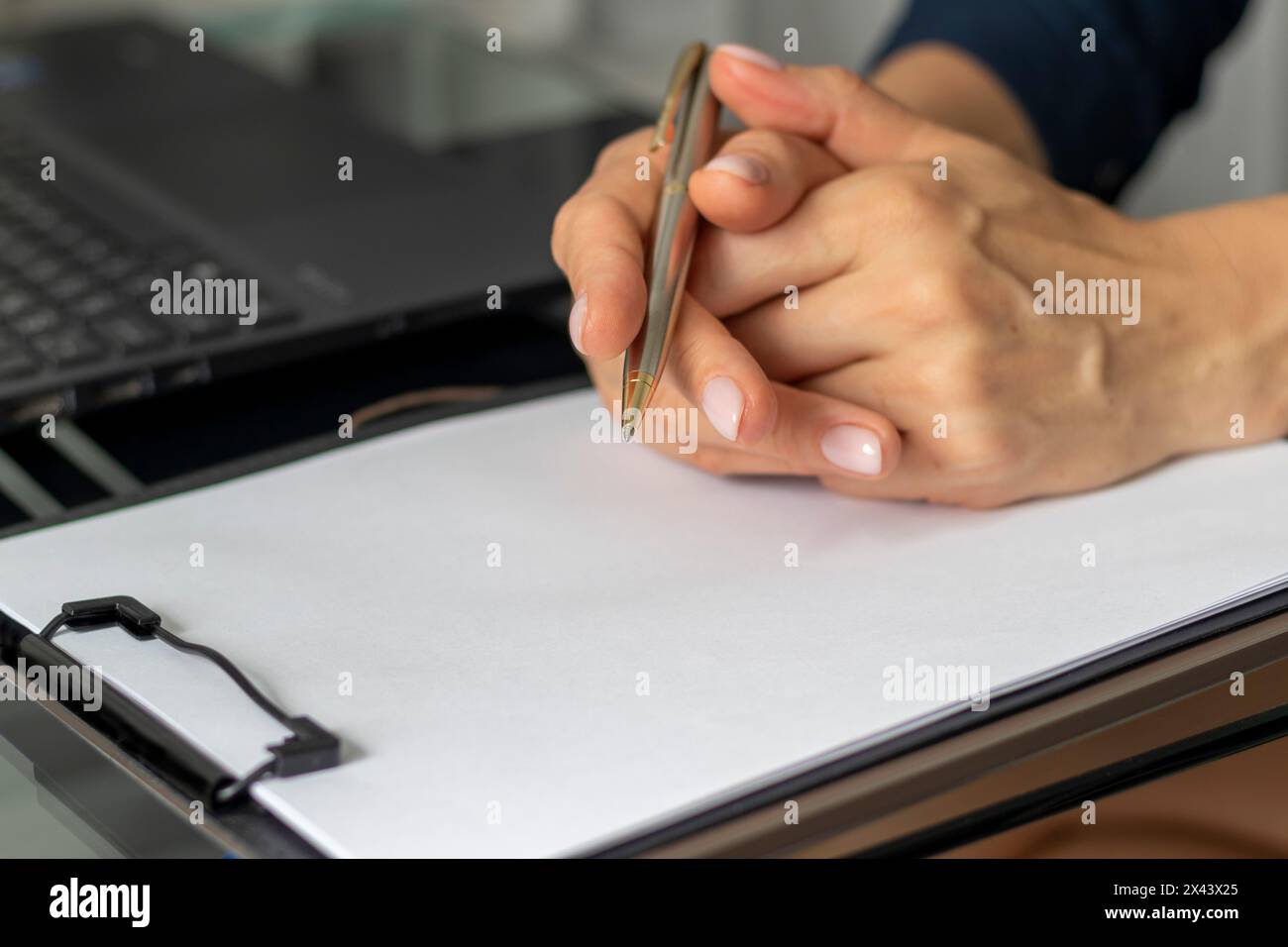 Close up shot of the woman with beautiful hands sitting in the meeting room during business meeting Stock Photo