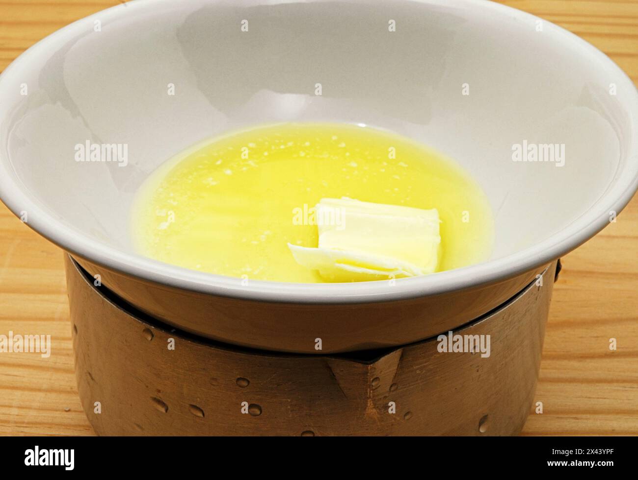 Melted butter in a double boiler. Stock Photo