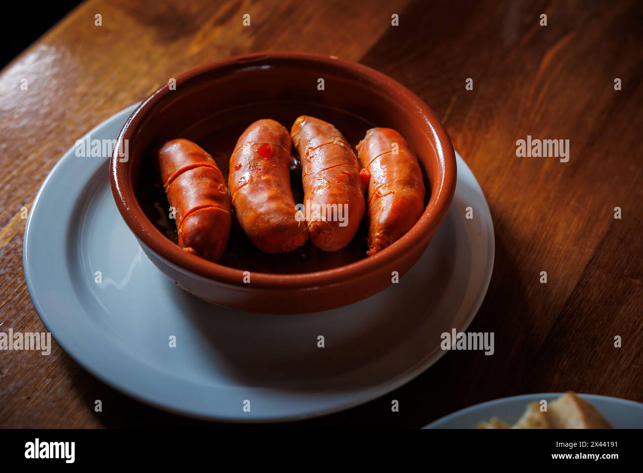 ready to eat fried chorizo plate tapa with bread Stock Photo - Alamy
