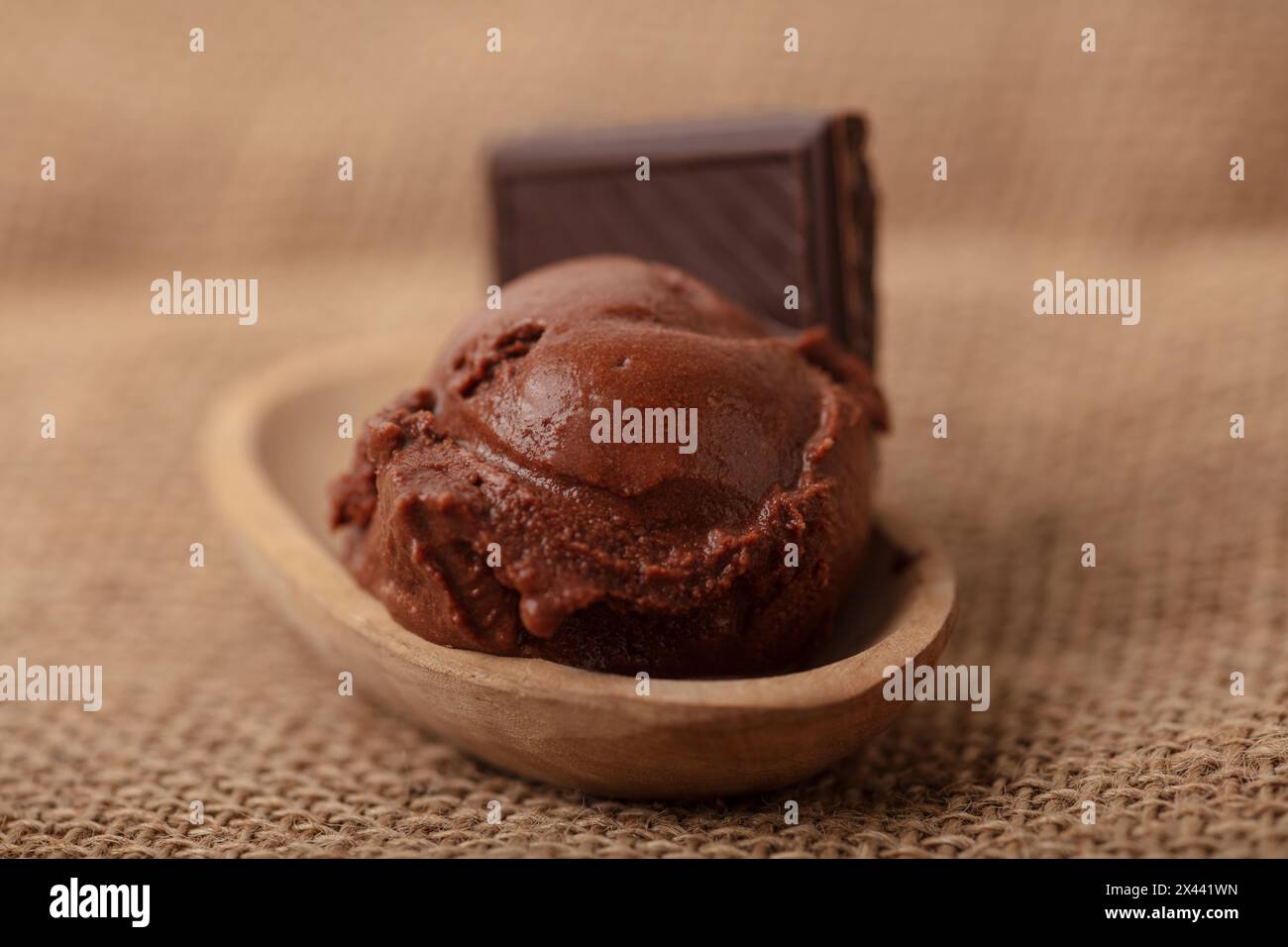 Fresh homemade scoop of chocolate ice cream in a bowl with a piece of chocolate Stock Photo
