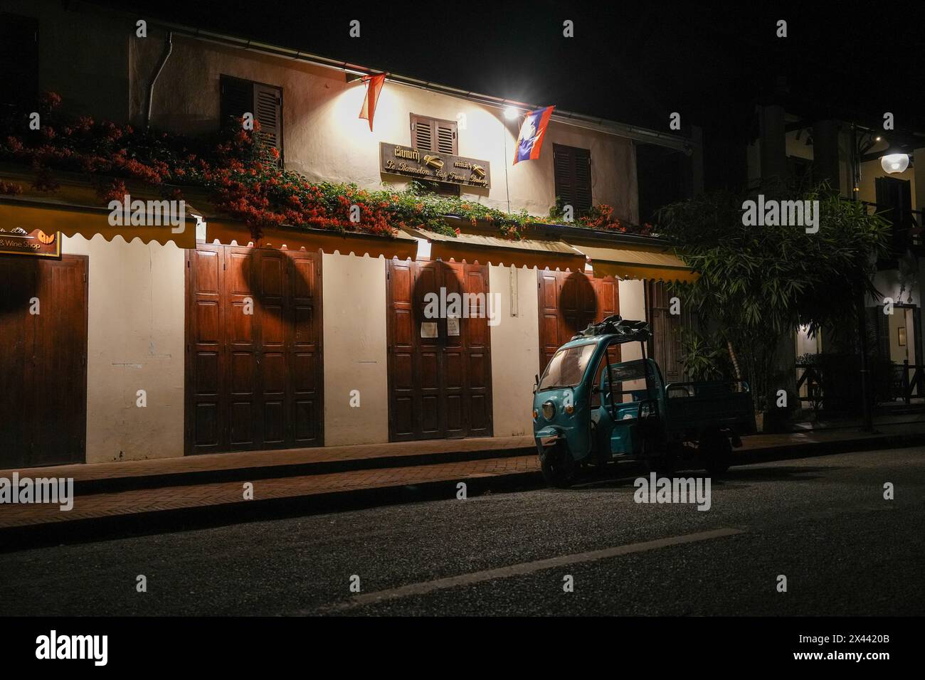 Nighttime street life with French colonial buildings in the historic old town of Luang Prabang, Laos Asia Stock Photo