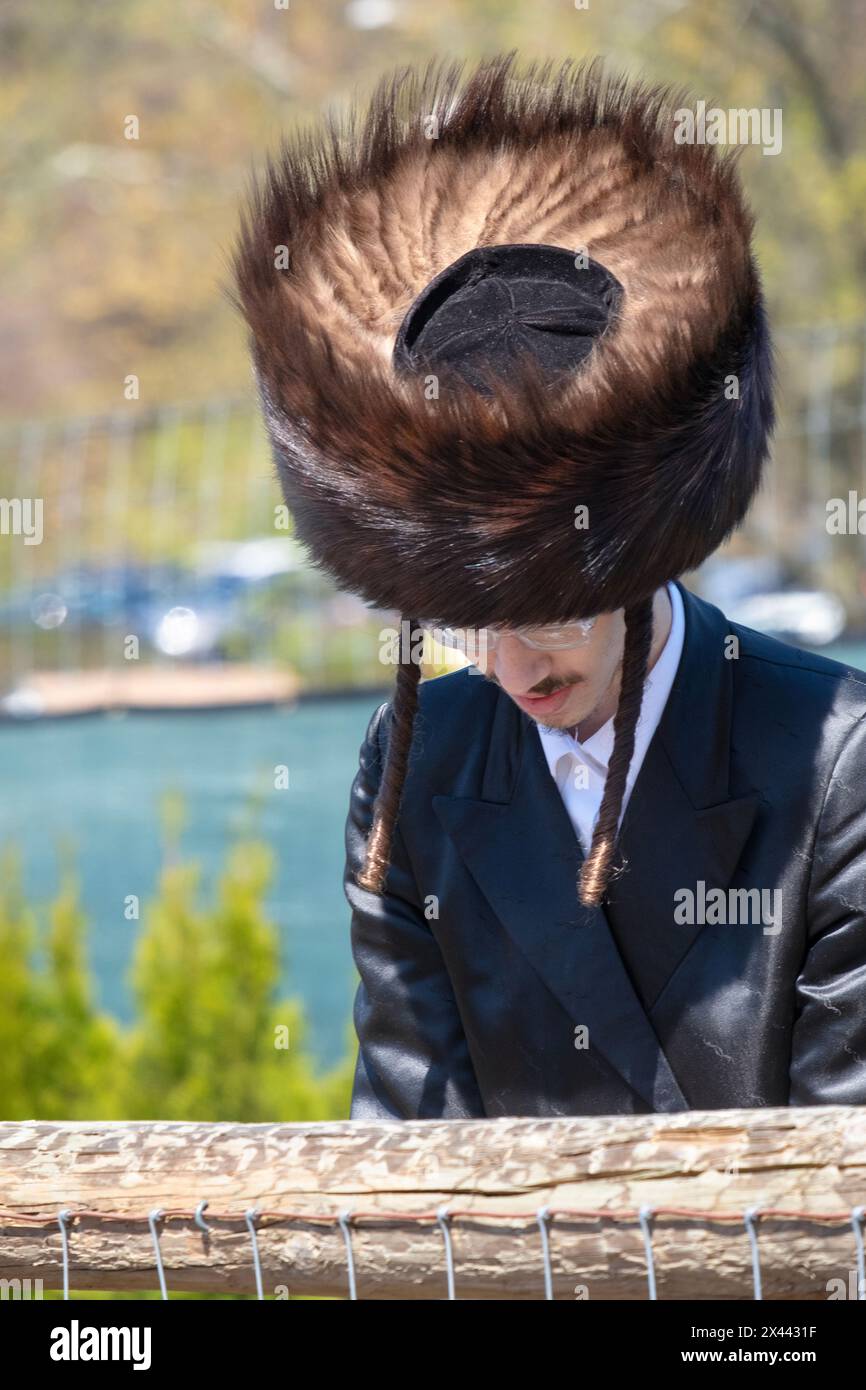 An orthodox Jewish man with long curled peyus wearing a shteimel fur hat. It's worn on Sabbath, holidays and some special personal celebrations. Stock Photo