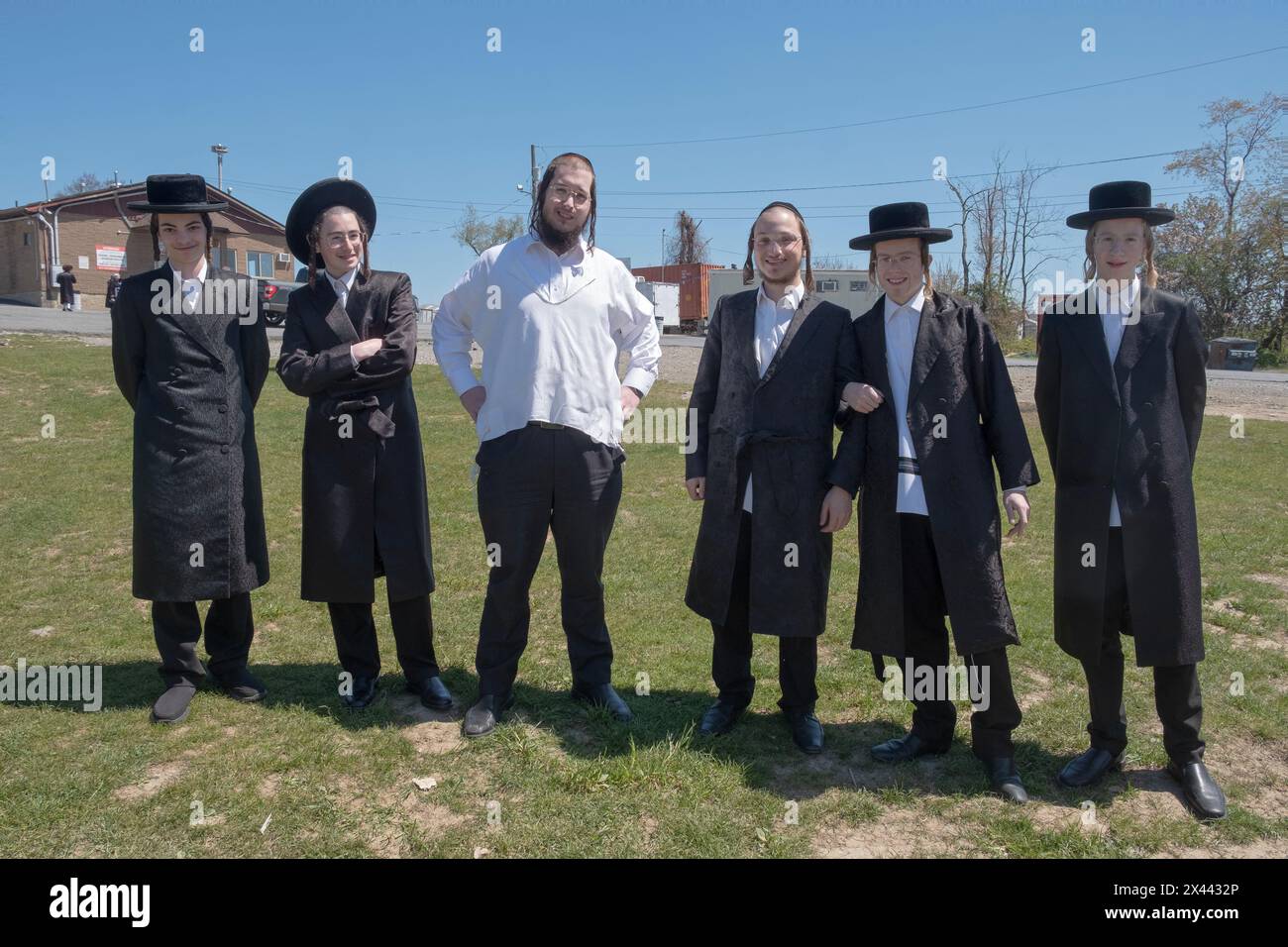 A posed photo of 7 orthodox Jewish boys from the Satmar Hasidic dynasty. Outdoors in Kiryas Joel, Rockland County, New York. Stock Photo