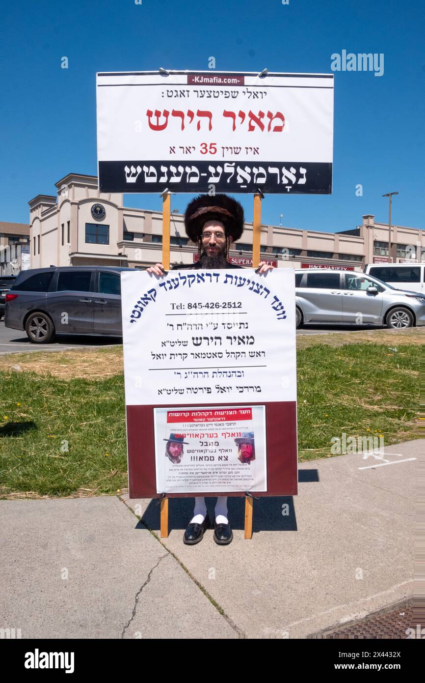 During Passover 2024, an orthodox Jewish man with Yiddish signs takes a