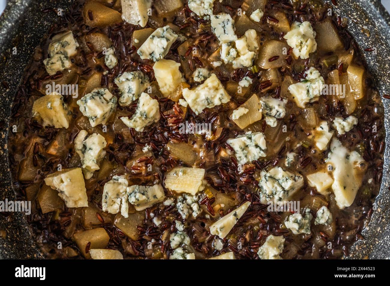 Closeup top view of frying pan with risotto with pear and blue cheese Stock Photo