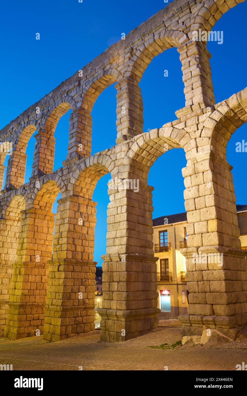 Night view from below the Roman aqueduct in the city of Segovia ...