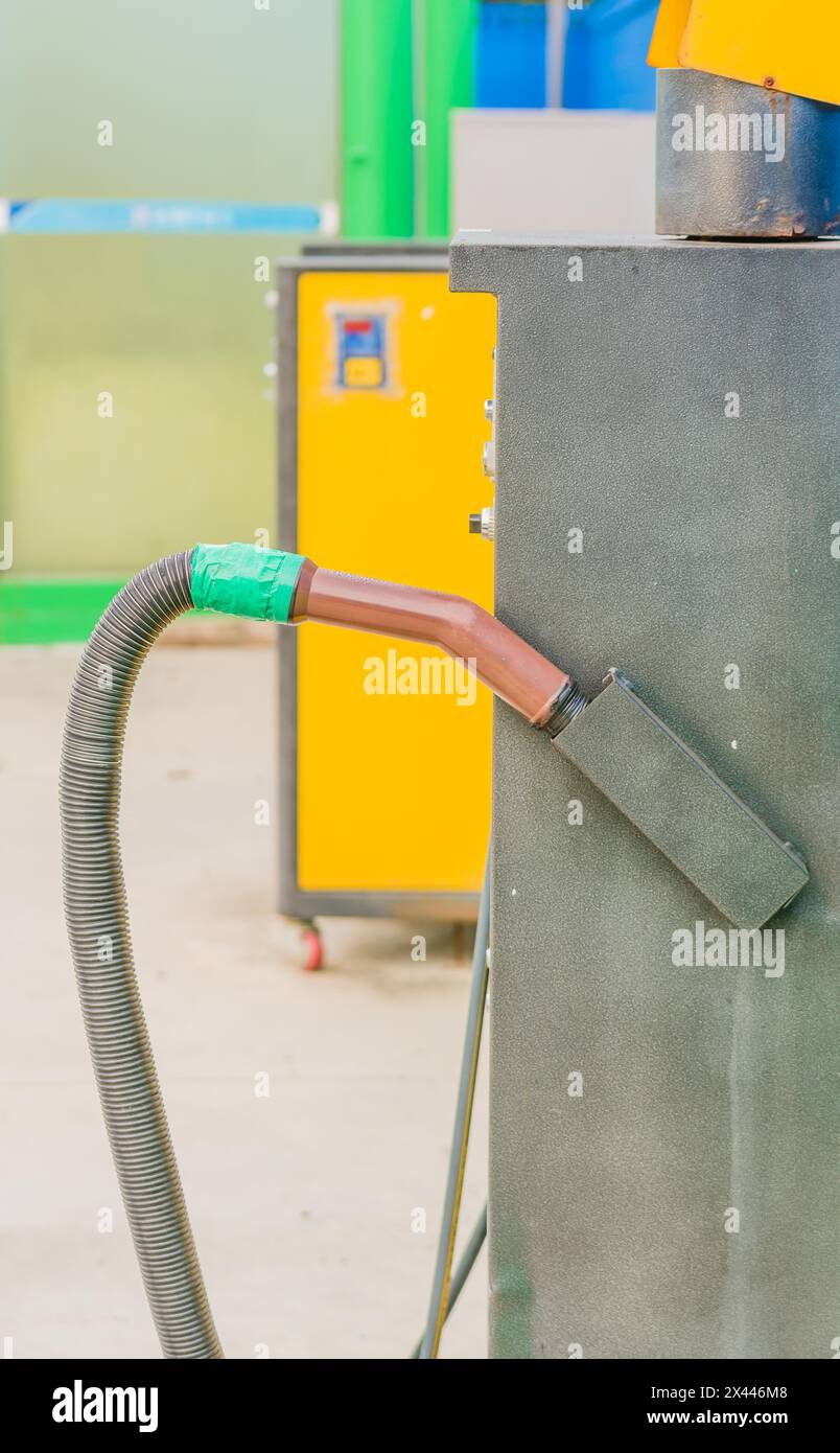 Brown vacuum cleaner handle with hose attached with green duct tape at