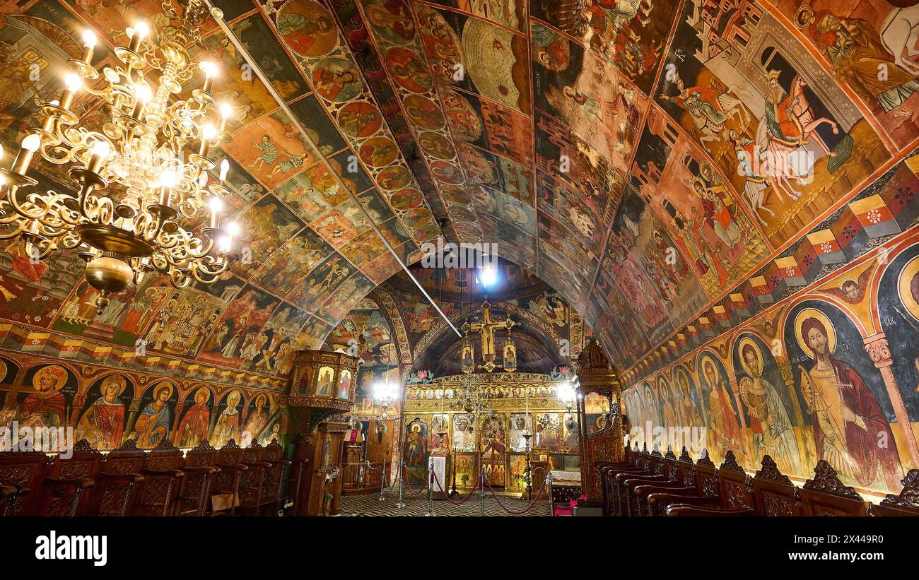 Interior view of an Orthodox church with richly decorated frescoes and ...