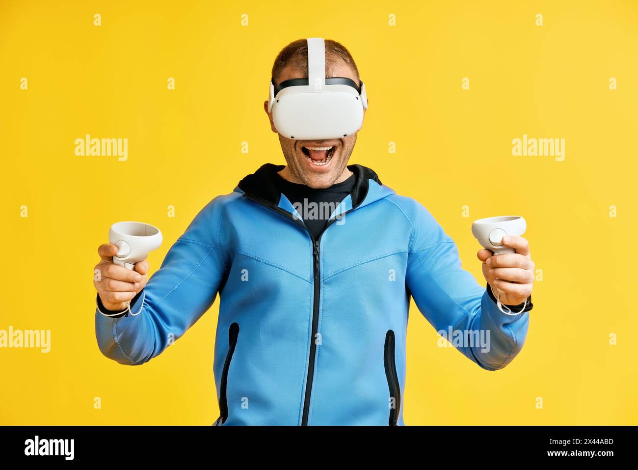 Man wearing virtual reality goggles over yellow background. Future concept Stock Photo