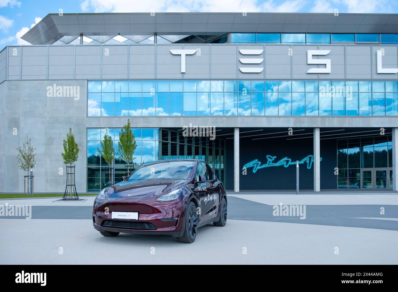 cherry red Tesla model y electric car front Gigafactory Berlin