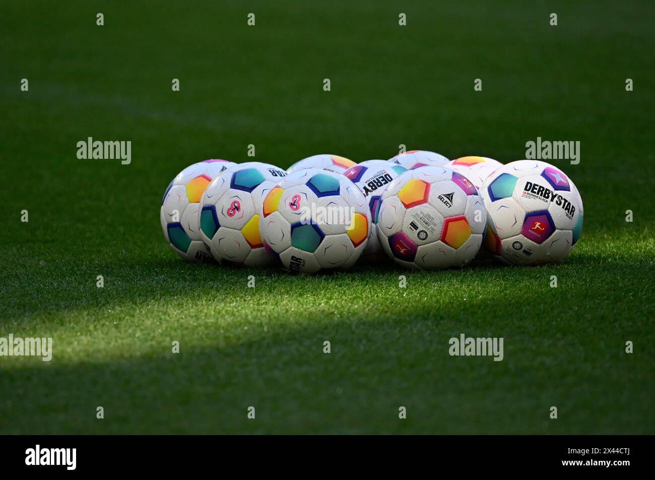 Adidas Derbystar match balls lie on grass, Allianz Arena, Munich, Bavaria, Germany Stock Photo