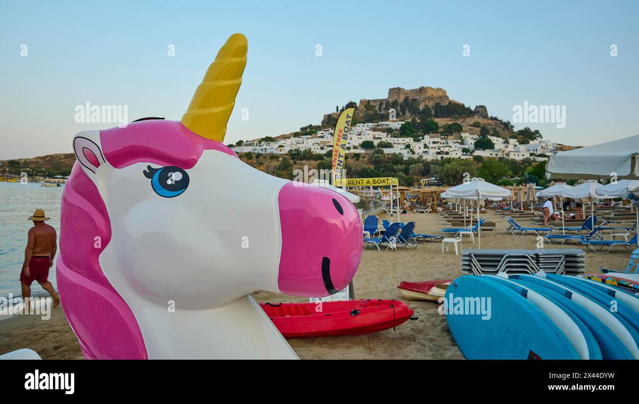 Sea Inflatables Rhodes Giant inflatable unicorn on the beach with a castle in the background ...