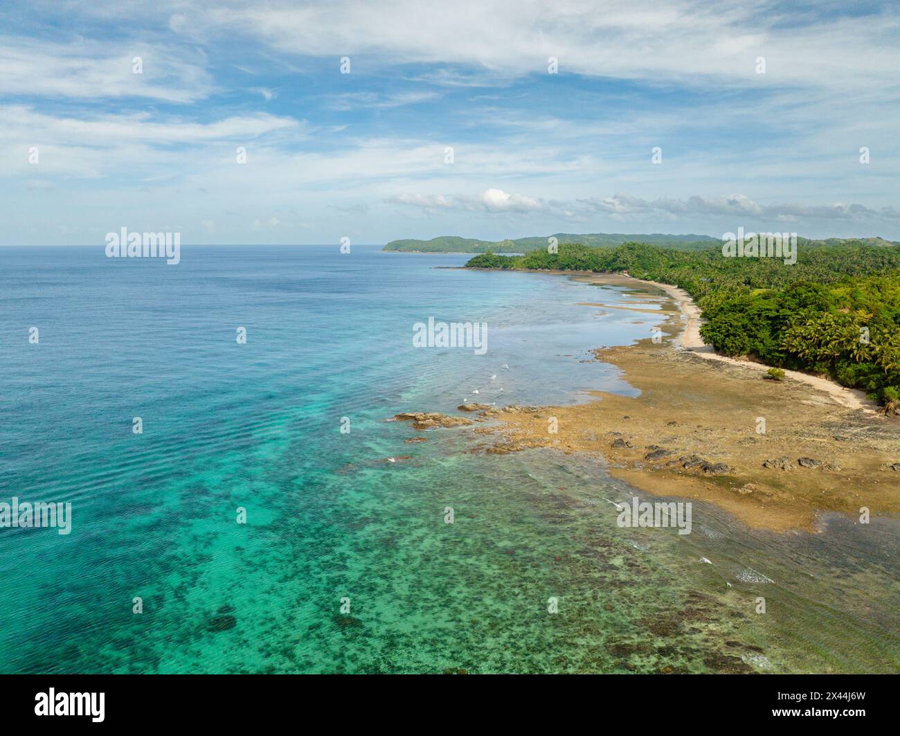 Drone view of turquoise sea water with coral reefs in tropical island ...