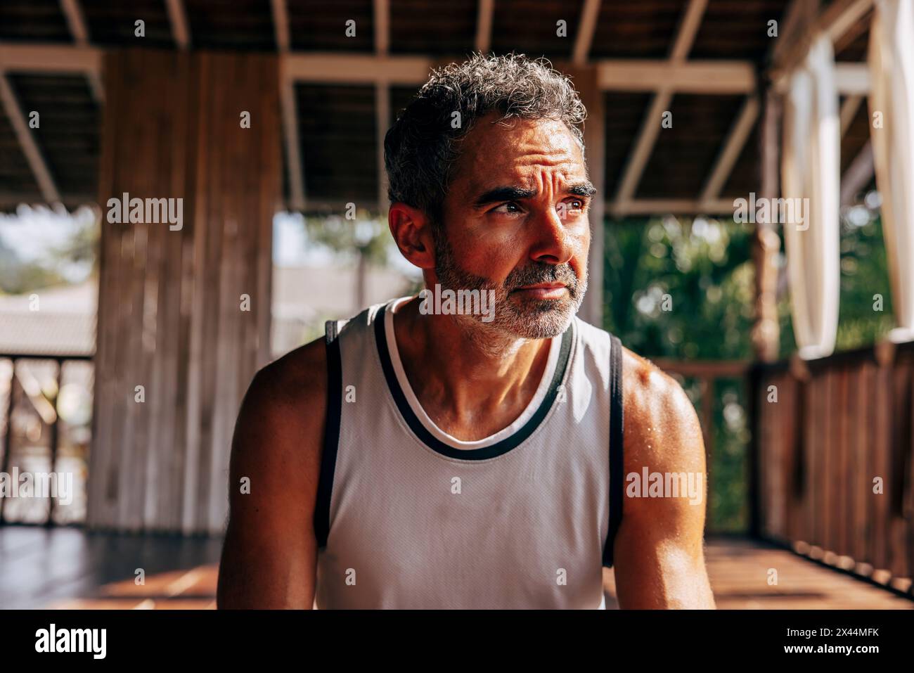 Thoughtful mature man looking away at wellness resort Stock Photo