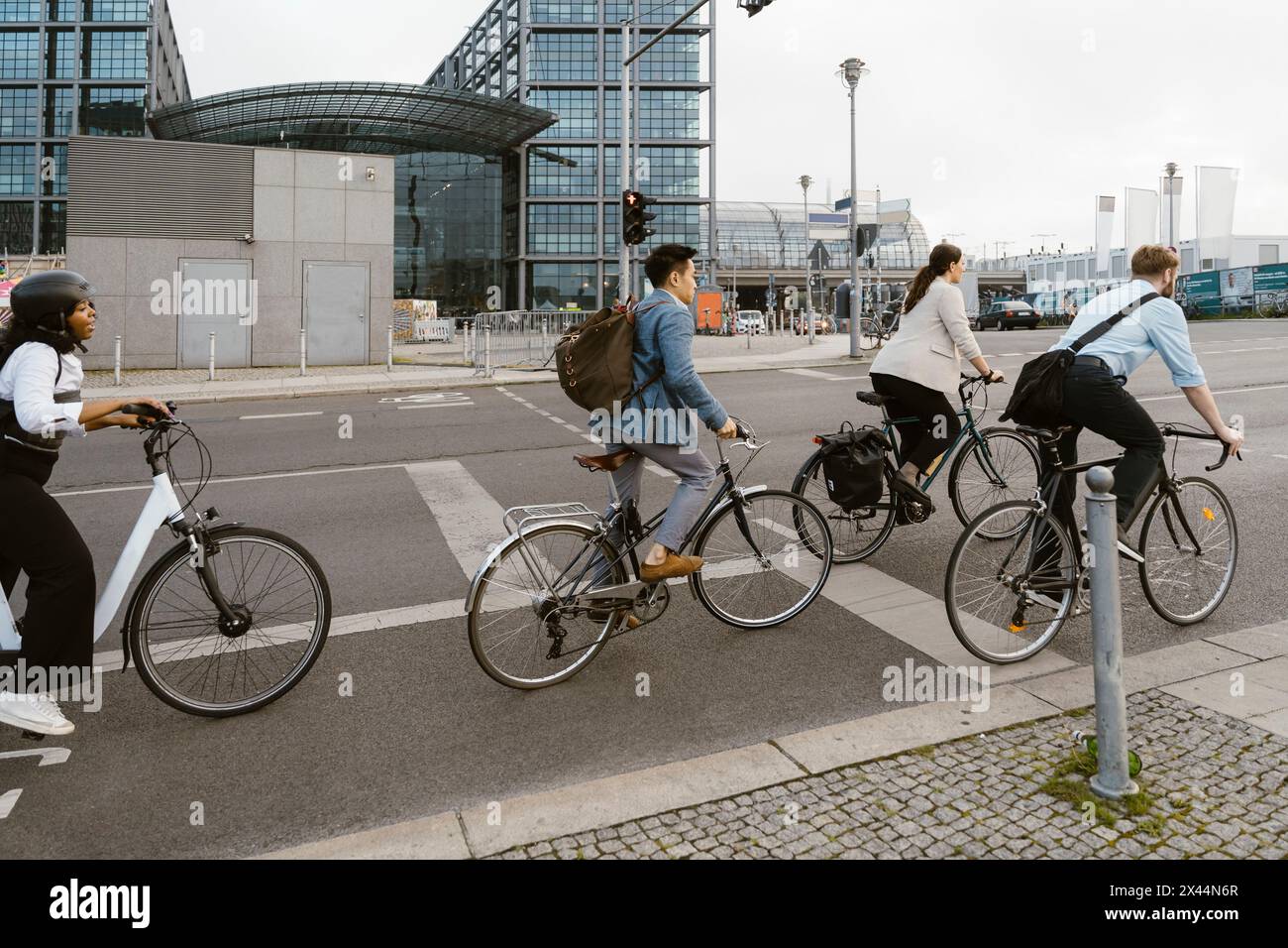 Business professionals cycling on bicycle lane in city Stock Photo