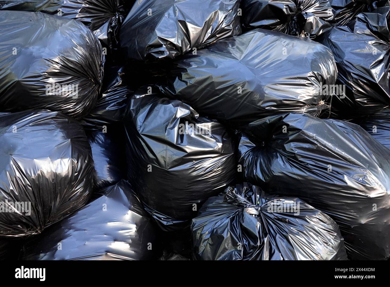Lot black filled garbage bags as background close-up Stock Photo