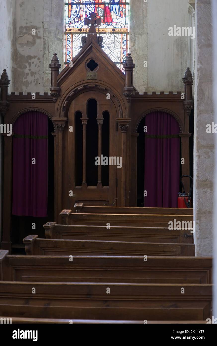Sainte-Marie-du-Mont, France - Apr 20, 2024: Sainte-Marie-du-Mont church. Bullet marks on the confessionalbullet marks on the confessional. Sunny spri Stock Photo