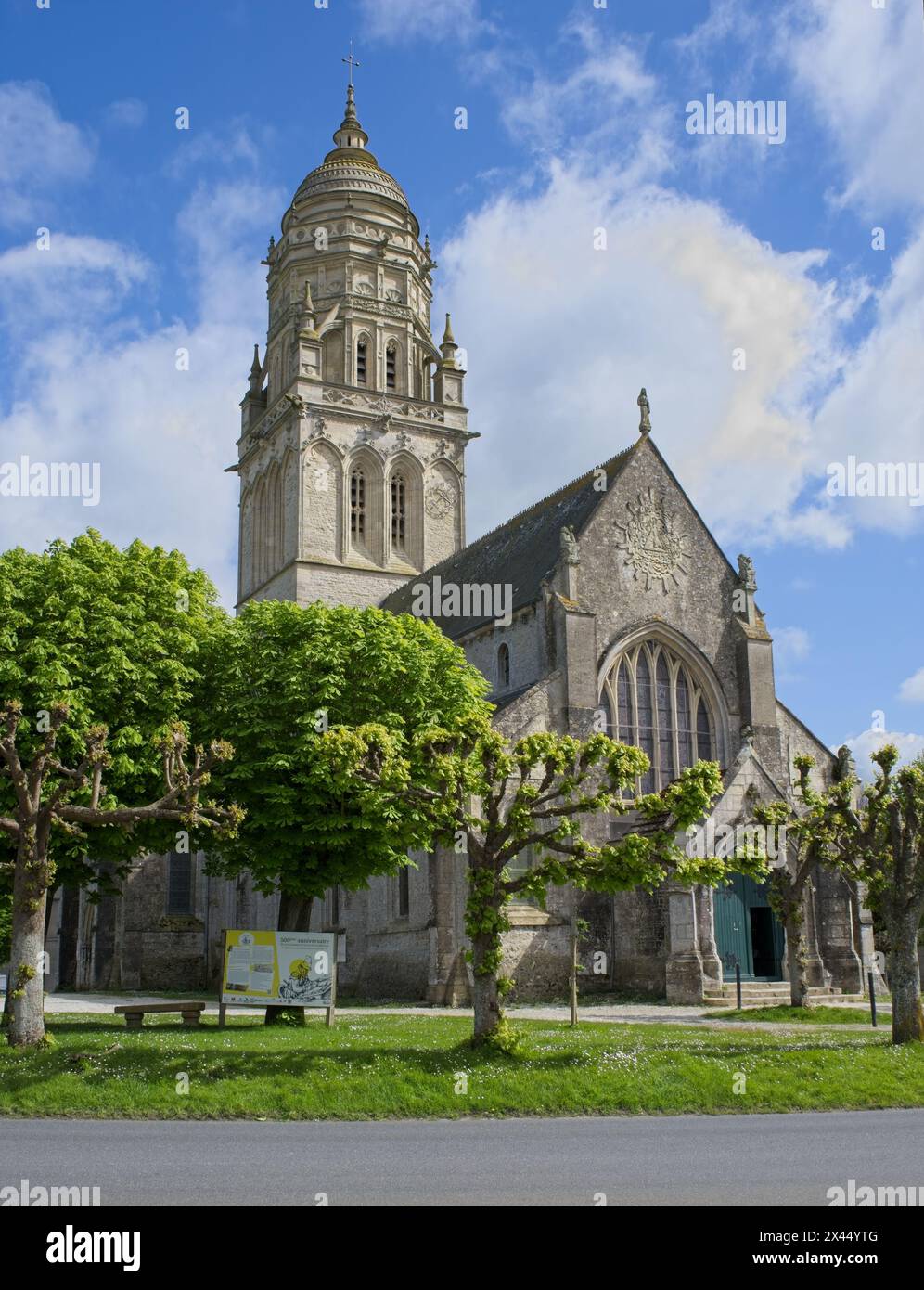 Sainte-Marie-du-Mont, France - Apr 20, 2024: Sainte-Marie-du-Mont church. People walking in Sainte-Marie-du-Mont. Streets and buildings. Lifestyle in Stock Photo