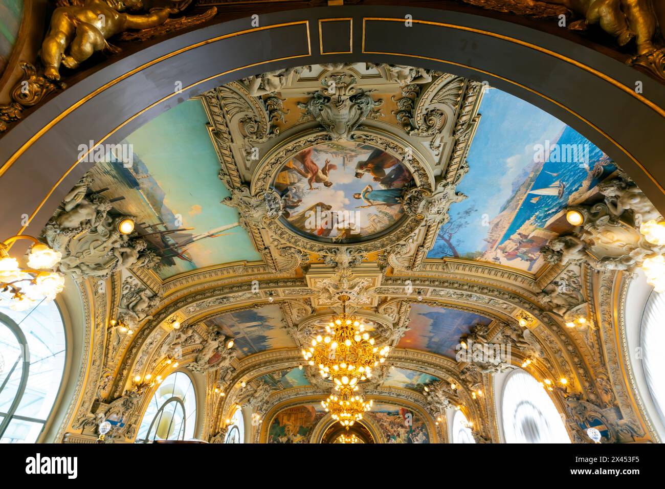Dining Room at Le Train Bleu, Gare de Lyon, Paris, France. Striking are the 41 sumptuous wall and ceiling paintings, which depict scenes from France. Stock Photo