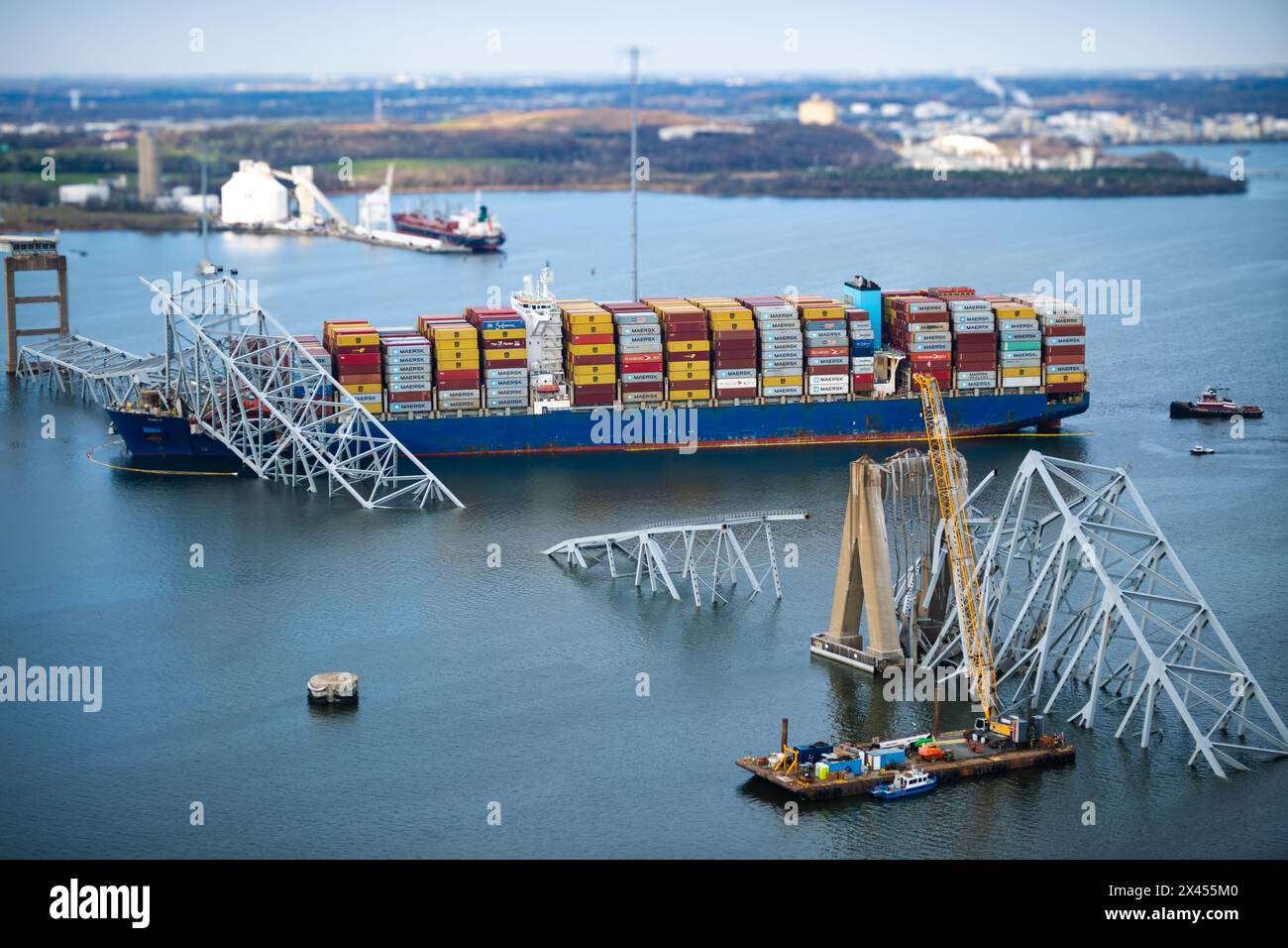 Dundalk, United States of America. 29 March, 2024. View from a Coast Guard MH-60 Jayhawk helicopter of the entangled cargo carrier MV Dali encased in the steel trusses of the collapsed Francis Scott Key Bridge blocking the Fort McHenry channel, March 29, 2024, near Dundalk, Maryland. The bridge was struck by the 984-foot container ship on March 26th and collapsed killing six workers. Credit: PO1 Brandon Giles/US Coast Guard/Alamy Live News Stock Photo