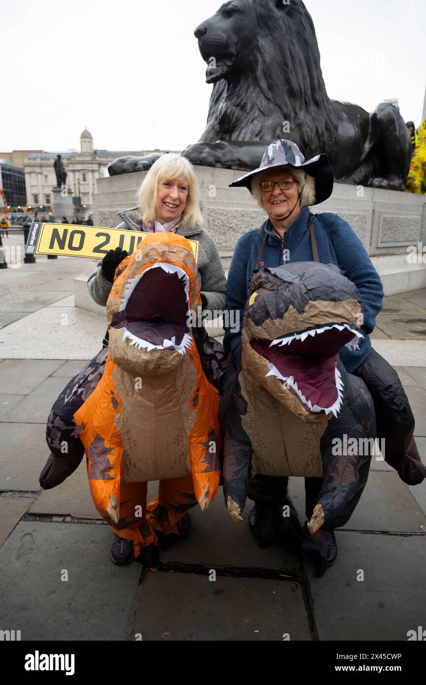 On April 27th as part of the campaign for Mayor of London people campaign against ULEZ in Trafalgar Square with two women in dinosaur costumes; Stock Photo
