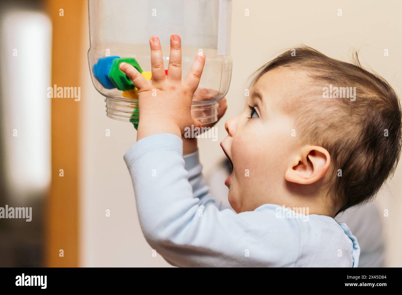 funny baby throwing toys Stock Photo Alamy