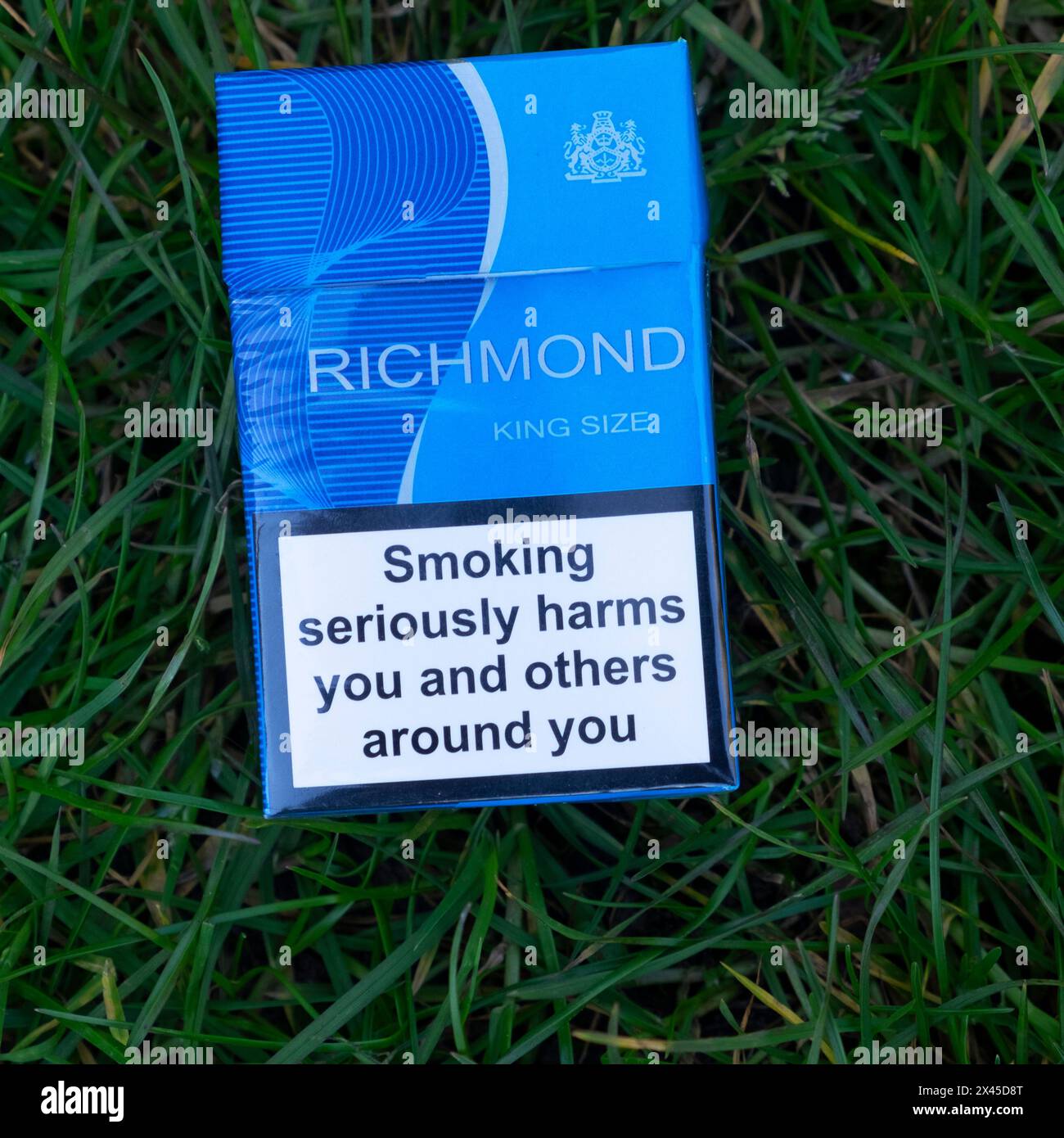 Packet of Richmond tobacco cigarettes cigarette health warning 'Smoking seriously harms you and others around you' on grass background Britain UK 2024 Stock Photo