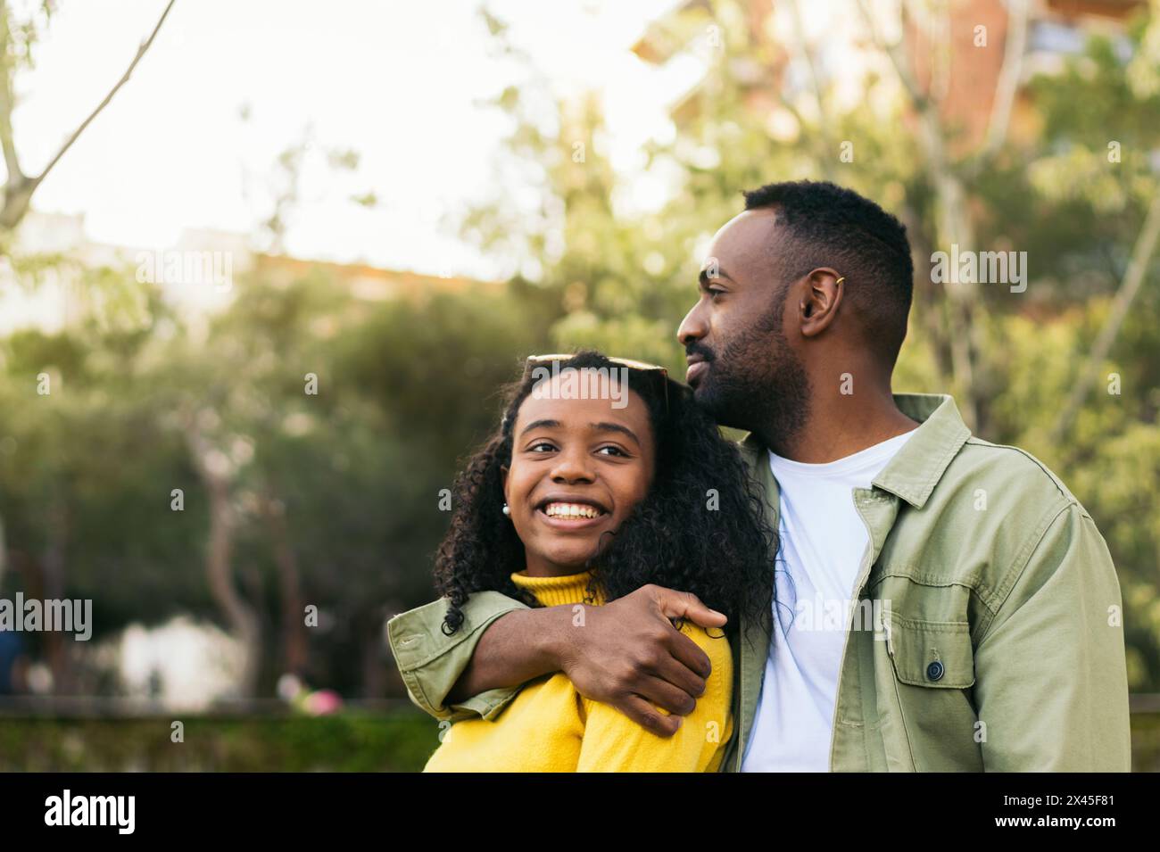 black man hugging afro american woman Stock Photo - Alamy