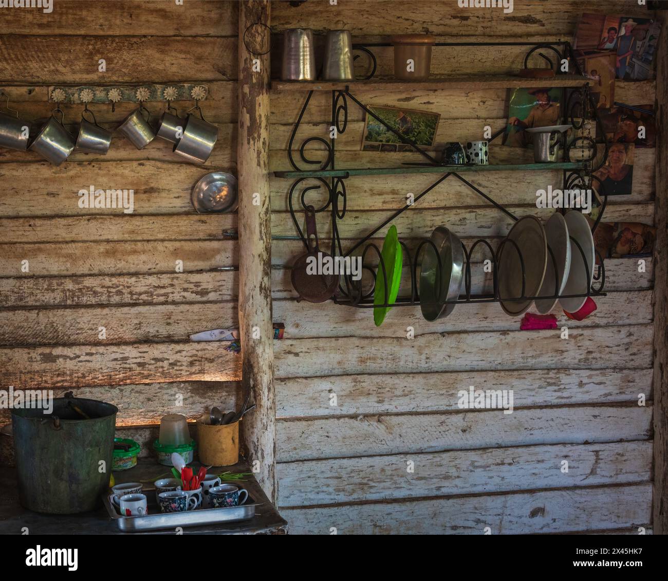Well used kitchen utensils hanging on the walls in the farmhouse at a coffee farm near Vinales, Cuba Stock Photo