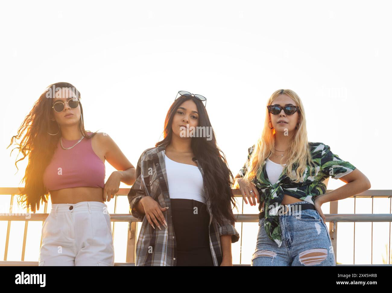Portrait of three multiethnic female friends with sunglasses outdoors in the city Stock Photo