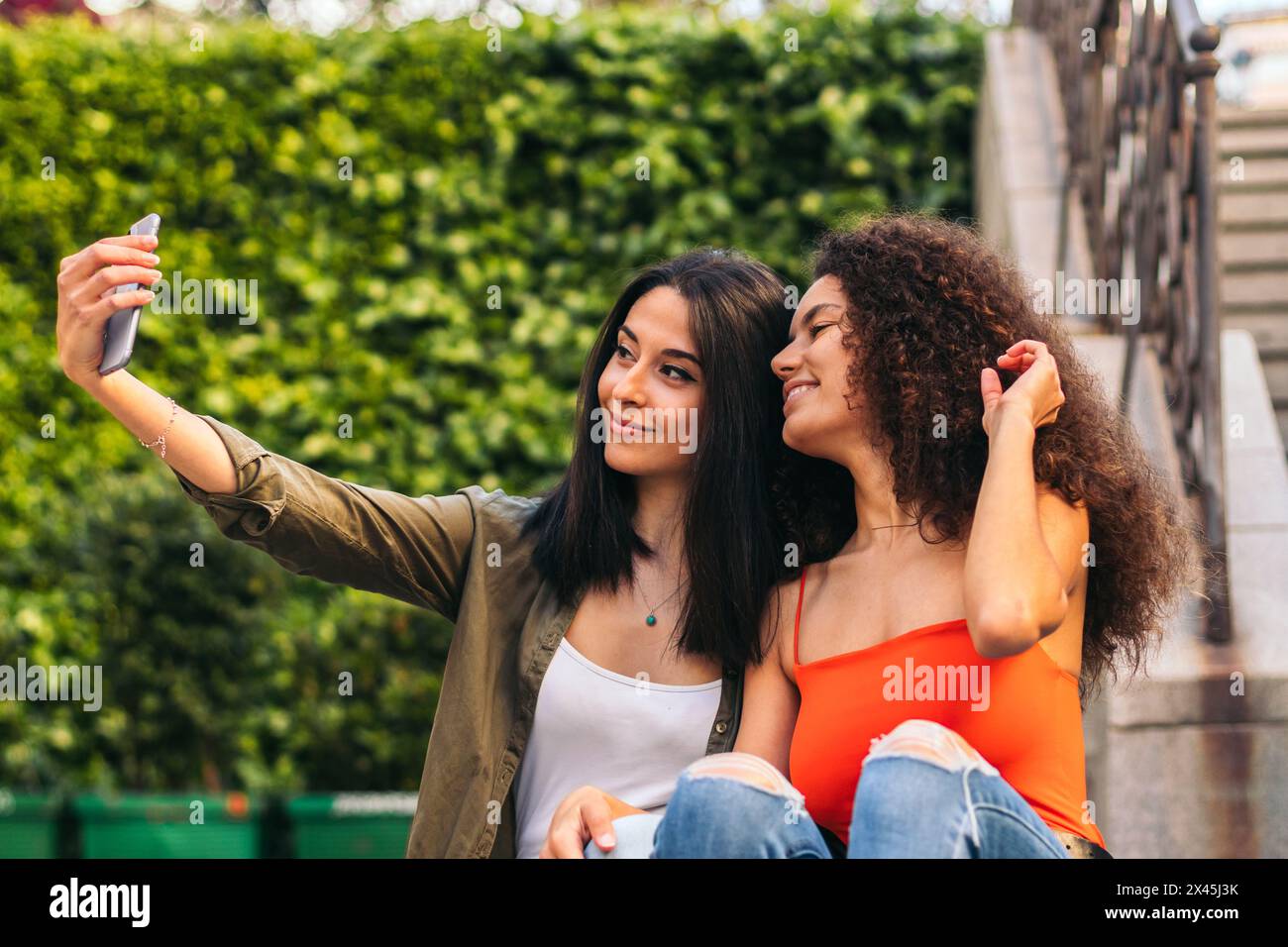 Two beautiful women sitting on hi-res stock photography and images - Alamy
