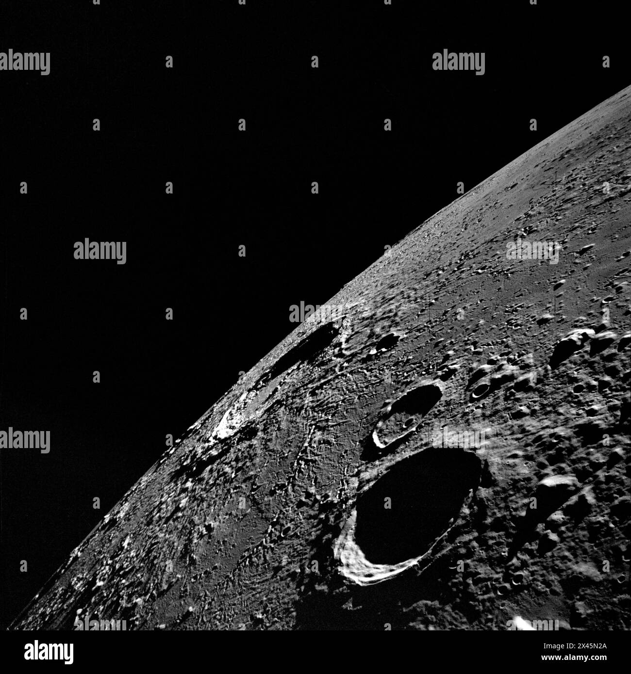 NASA Apollo 12  photo of the moon crater Copernicus (in center near horizon), as photographed from lunar orbit. 1969 Stock Photo