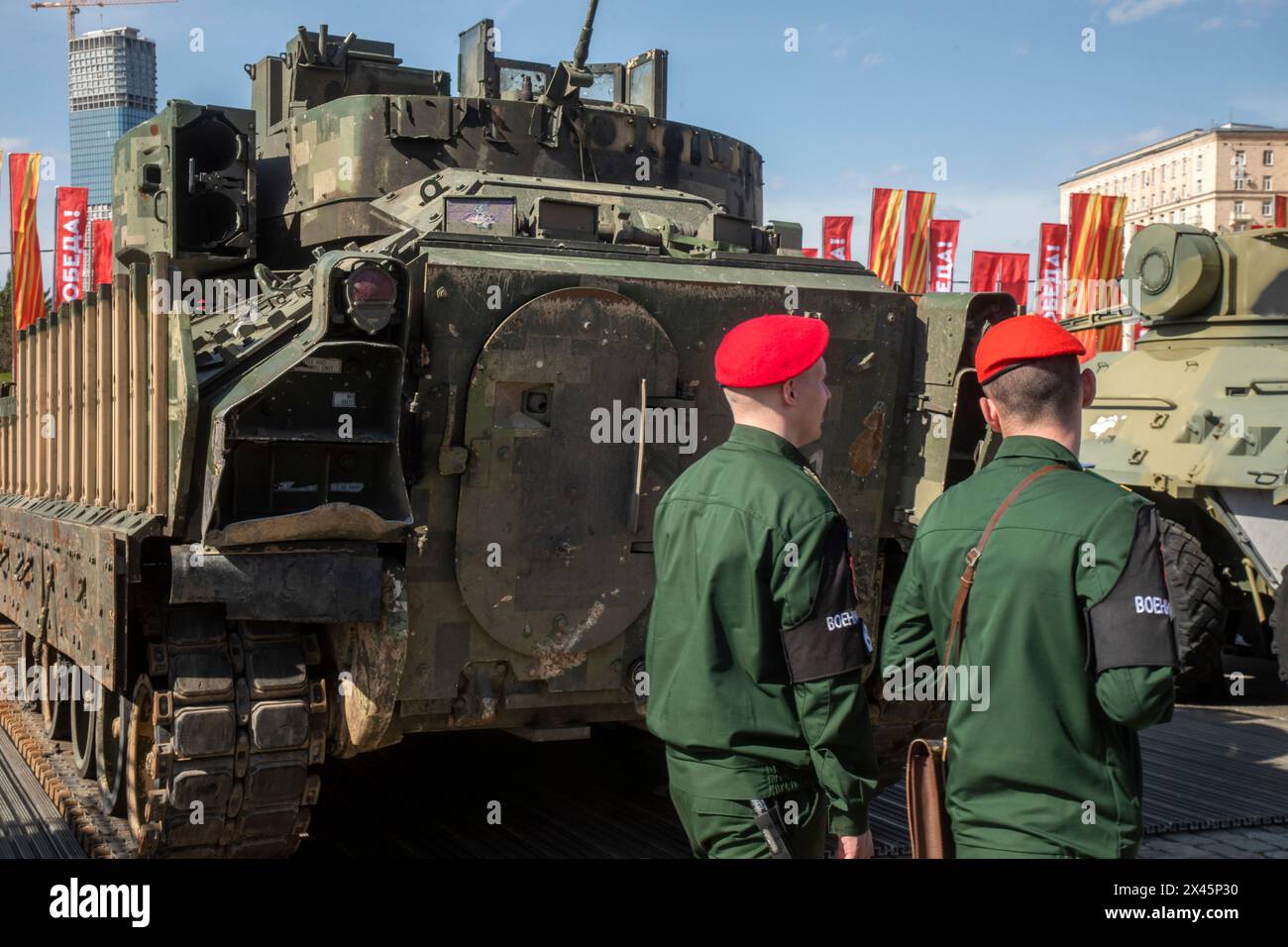 Moscow, Russia. 30th of April, 2024. Russian soldiers guard an area with armoured military vehicles that belonged to the Ukrainian army on display at the Victory park WWII memorial complex in Moscow, Russia. The Russian military put some of the equipment captured from Ukrainian forces on display in Moscow Stock Photo