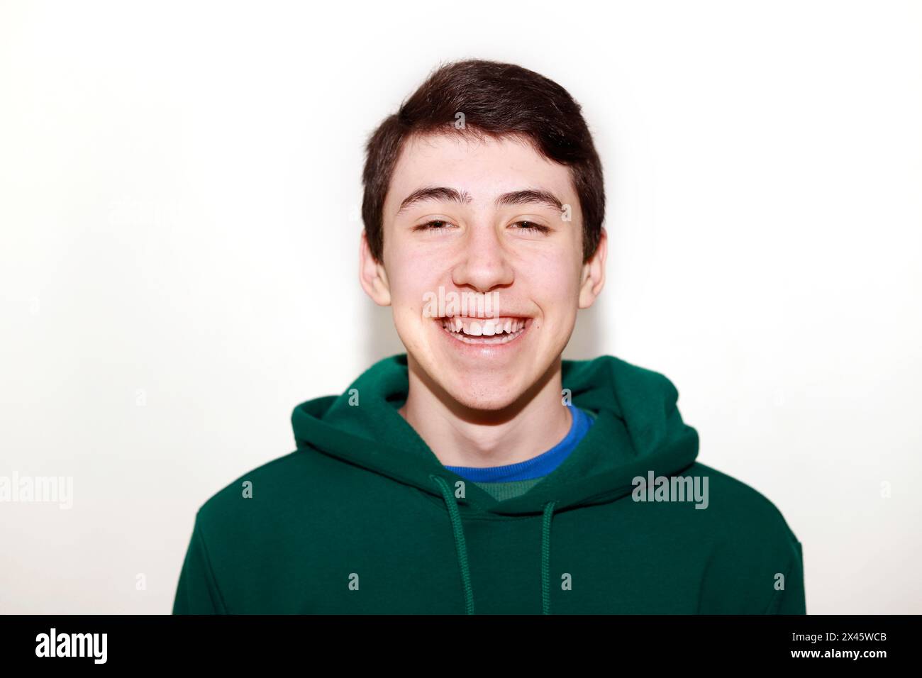 teenager looking at camera laughing on white background Stock Photo