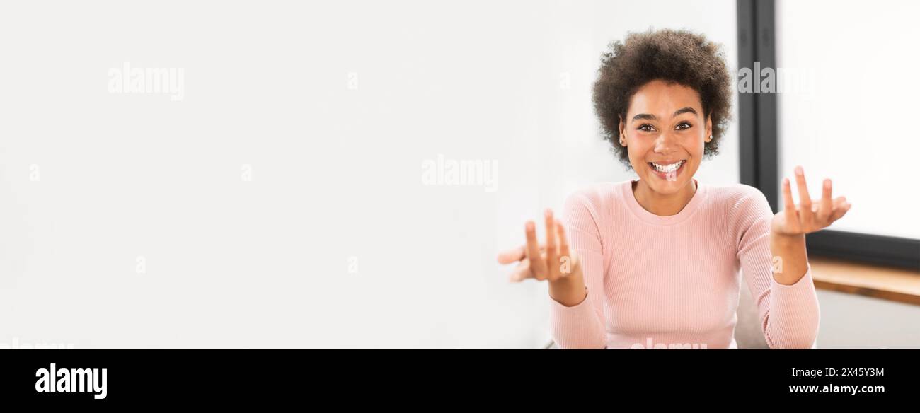 Woman gesturing during a virtual meeting at office Stock Photo