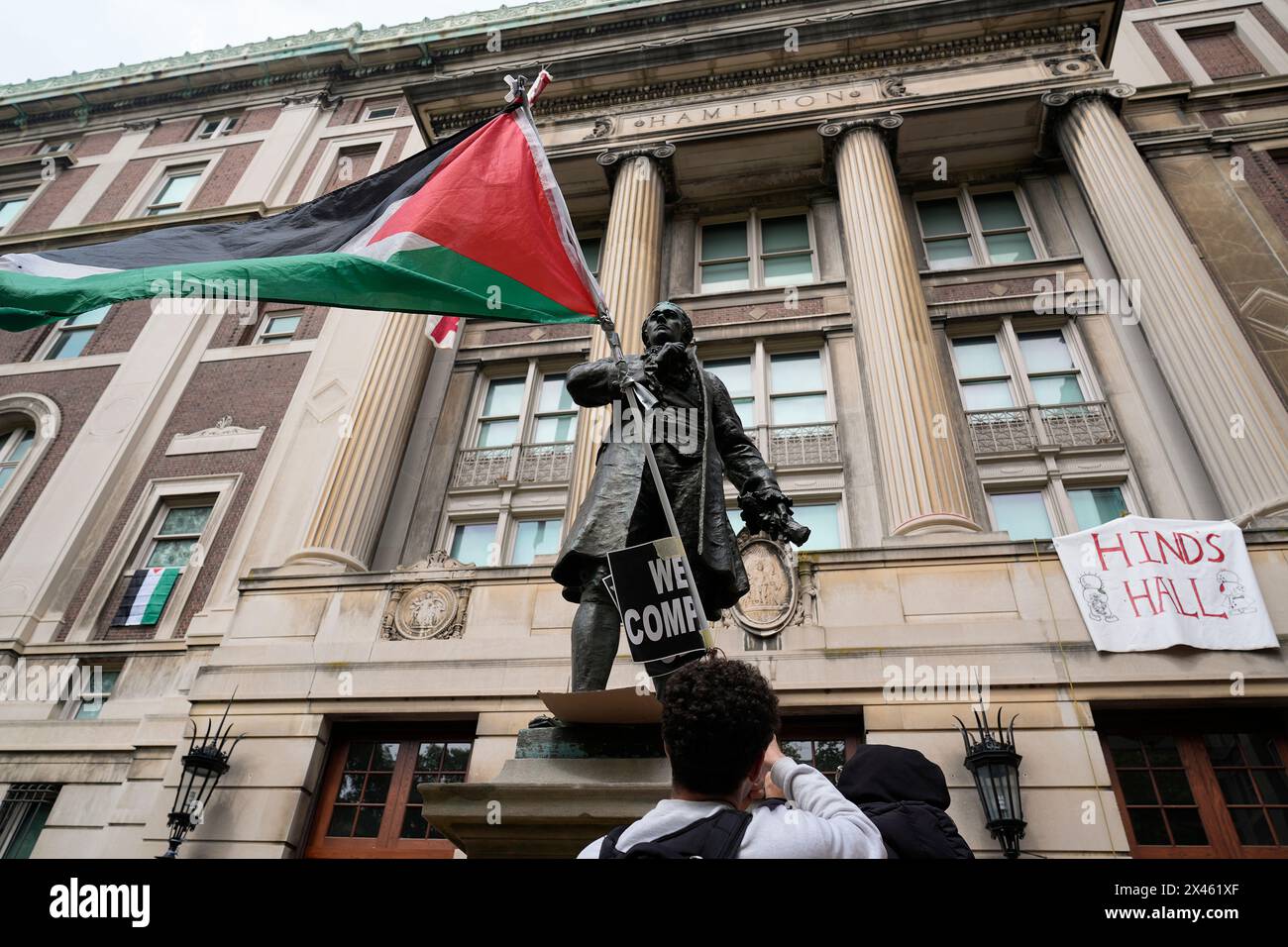 New York, USA. 30th Apr, 2024. A student protester parades a Palestinian flag outside the entrance to Hamilton Hall on the campus of Columbia University, Tuesday, April 30, 2024, in New York. Early Tuesday, dozens of protesters took over Hamilton Hall, locking arms and carrying furniture and metal barricades to the building. Columbia responded by restricting access to campus. (Photo by Mary Altaffer/Pool/Sipa USA) Credit: Sipa USA/Alamy Live News Stock Photo