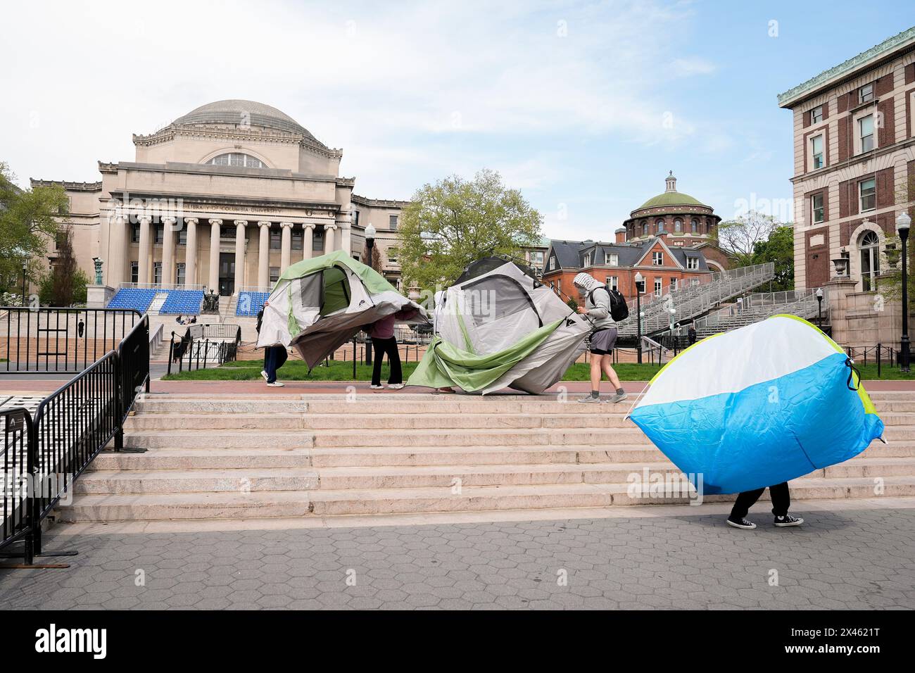 New York, USA. 30th Apr, 2024. Student protesters move tents from the center of campus to entrance to Hamilton Hall on the campus of Columbia University, Tuesday, April 30, 2024, in New York. Early Tuesday, dozens of protesters took over Hamilton Hall, locking arms and carrying furniture and metal barricades to the building. Columbia responded by restricting access to campus. (Photo by Mary Altaffer/Pool/Sipa USA) Credit: Sipa USA/Alamy Live News Stock Photo