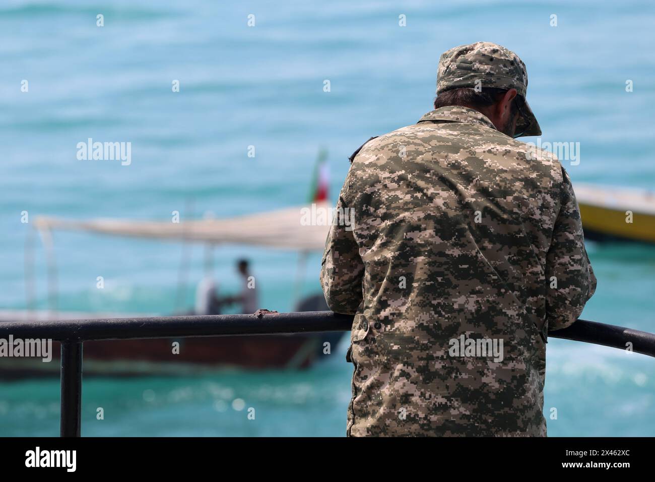 April 29, 2024, Persian Gulf, Bushehr, Iran: A member of The Islamic Revolutionary Guard Corps Navy (IRGCN) monitors the area on board a warship along the Persian Gulf during the IRGC marine parade to commemorate Persian Gulf National Day near the Bushehr nuclear power plant in the seaport city of Bushehr, Bushehr province, southern Iran. Iran celebrates the anniversary of the liberation of the country's south from Portuguese occupation in 1622 as 'Persian Gulf National Day' in Bushehr on April 29, 2024. The date coincides with the anniversary of a successful military campaign by Shah Abbas, t Stock Photo