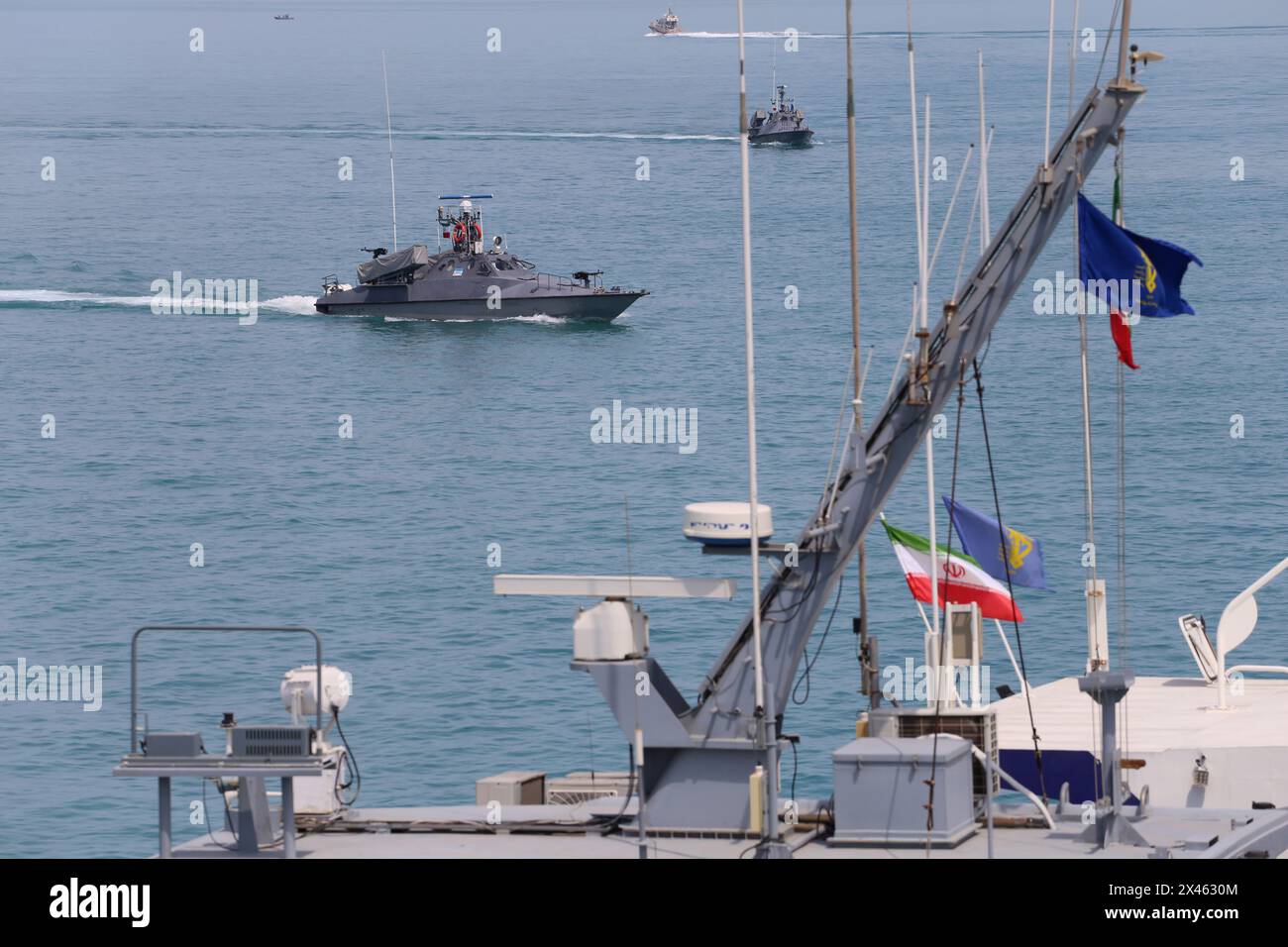 April 29, 2024, Persian Gulf, Bushehr, Iran: The Islamic Revolutionary Guard Corps (IRGC) speed boats are sailing along the Persian Gulf during the IRGC marine parade to commemorate Persian Gulf National Day near the Bushehr nuclear power plant in the seaport city of Bushehr, Bushehr province, in the south of Iran. Iran celebrates the anniversary of the liberation of the country's south from Portuguese occupation in 1622 as 'Persian Gulf National Day' in Bushehr on April 29, 2024. The date coincides with the anniversary of a successful military campaign by Shah Abbas, the Great of Persia, in t Stock Photo