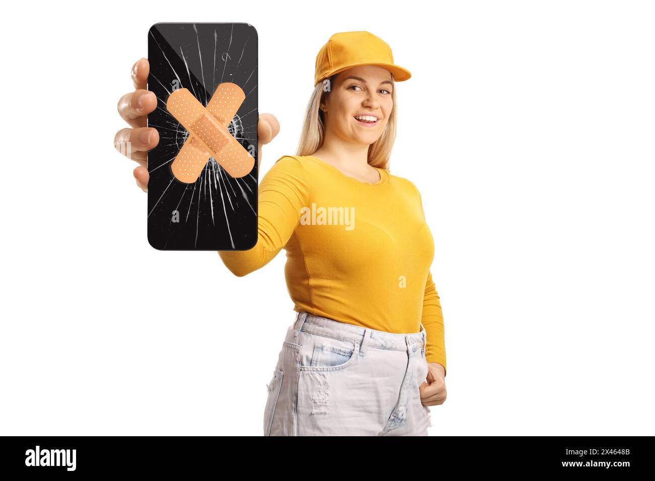 Female teenager holding a smartphone with broken screen glass and bandage isolated on white background Stock Photo